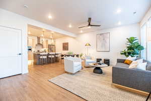 Living room featuring hardwood / wood-style flooring and ceiling fan