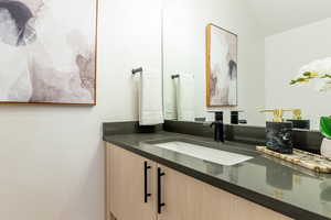 Bathroom with vanity and vaulted ceiling