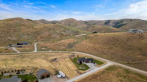 Birds eye view of property with a mountain view and a rural view