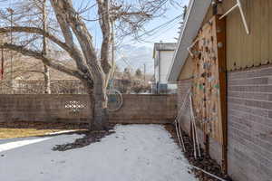 Yard layered in snow featuring a mountain view