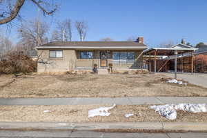 View of front of house featuring a carport and a porch