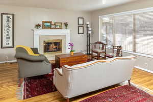 Living room featuring hardwood / wood-style floors and a tile fireplace