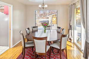 Dining area with an inviting chandelier and light hardwood / wood-style floors