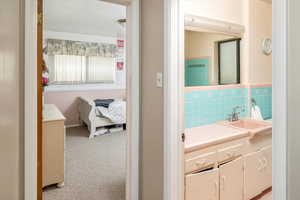 Bathroom featuring tasteful backsplash and vanity