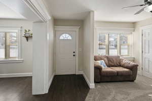 Entryway with dark hardwood / wood-style flooring and ceiling fan