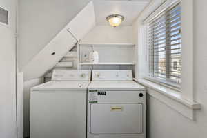 Washroom with washing machine and clothes dryer