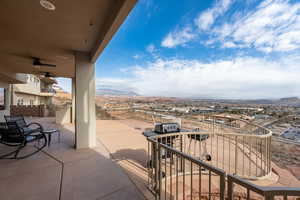 View of patio / terrace with ceiling fan, a mountain view, and a balcony