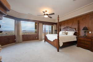 Bedroom with ceiling fan, wooden walls, a mountain view, and light carpet