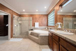 Bathroom featuring tile patterned floors, separate shower and tub, and vanity