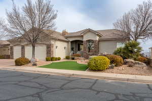 View of front of property featuring a garage and a front yard