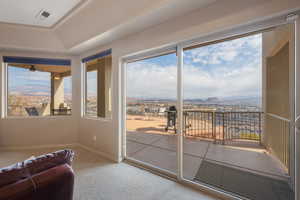 Entryway featuring a tray ceiling, carpet flooring, and a mountain view