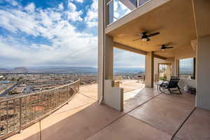 View of patio / terrace with ceiling fan and a mountain view