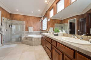 Bathroom featuring vanity, tile patterned flooring, and separate shower and tub