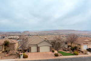 Ranch-style house with a garage and a mountain view