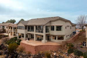 Back of property with a patio and central AC