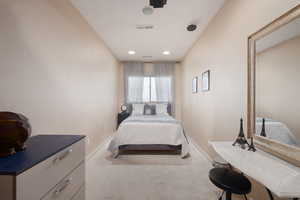 Bedroom featuring light colored carpet