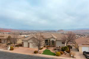 View of front of home with a garage and a mountain view