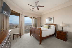 Bedroom with multiple windows, light carpet, and ceiling fan