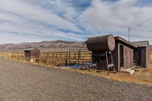 View of outdoor structure with a mountain view and a rural view