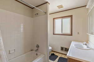 Full bathroom with vanity, crown molding, shower / bath combination with curtain, and a textured ceiling