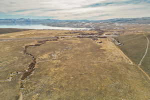 Birds eye view of property with a water and mountain view