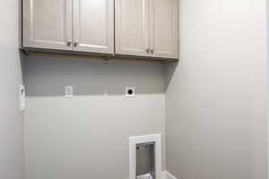 Laundry area featuring cabinets and electric dryer hookup