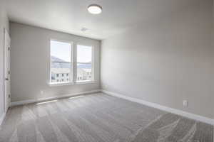 Carpeted spare room featuring a mountain view