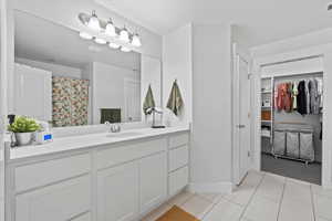 Bathroom with tile patterned flooring and vanity