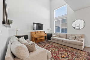 Living room featuring a towering ceiling and carpet