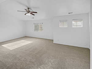 Carpeted empty room featuring ceiling fan