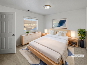 Carpeted bedroom featuring a textured ceiling