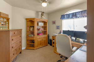 Home office featuring light colored carpet and ceiling fan