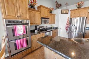 Kitchen with appliances with stainless steel finishes and tile patterned floors