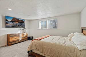 Bedroom featuring carpet floors and a textured ceiling