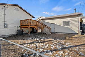 Snow covered property featuring central AC and a deck