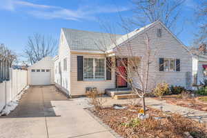 View of front of home featuring a garage and an outdoor structure