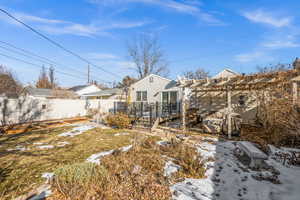 Yard layered in snow featuring a pergola and a deck