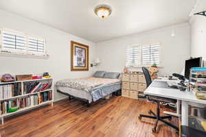 Bedroom with crown molding and hardwood / wood-style flooring