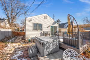 Rear view of property featuring a patio and hot tub