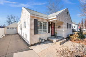 View of front of property featuring a garage and an outdoor structure