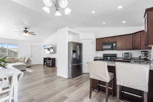 Kitchen featuring vaulting ceiling