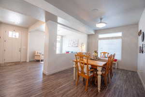 Dining space featuring dark wood-type flooring