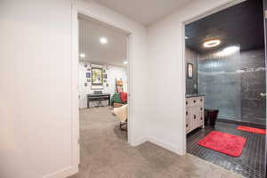 Corridor featuring light carpet