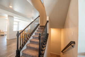 Stairway with hardwood / wood-style floors