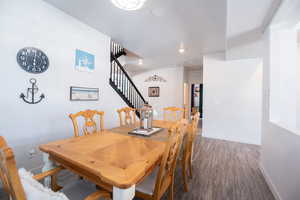 Dining area with dark hardwood / wood-style floors