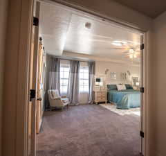 Unfurnished bedroom featuring carpet, a textured ceiling, and ceiling fan