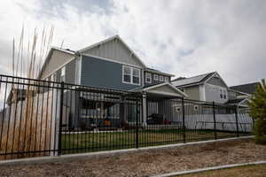 View of front of house with a fenced front yard and board and batten siding