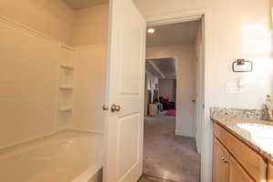 Bathroom with vanity and shower / tub combination