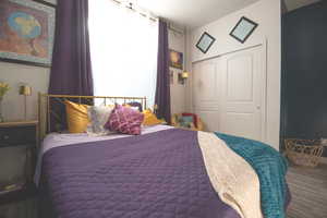 Bedroom with hardwood / wood-style flooring and a closet