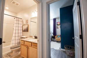 Full bathroom featuring vanity, toilet, and shower / bath combo with shower curtain